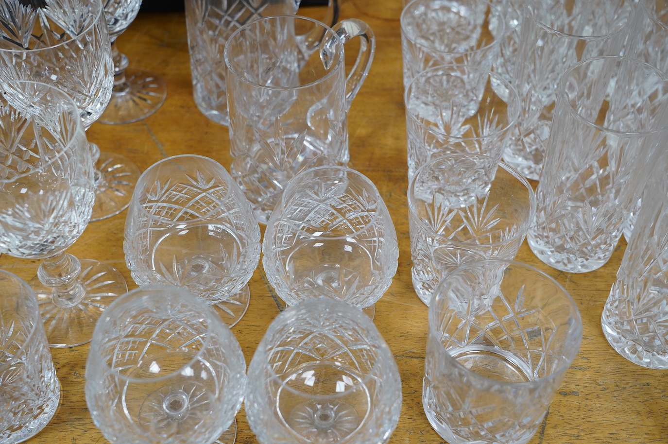 A collection of crystal glassware to include a set of ten tankards, wine glasses and tumblers, tallest 19cm. Condition - varies, mostly fair